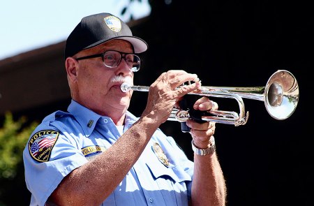 Lemoore Police Volunteer Tracy Landrus plays Taps at the end of the ceremony. 